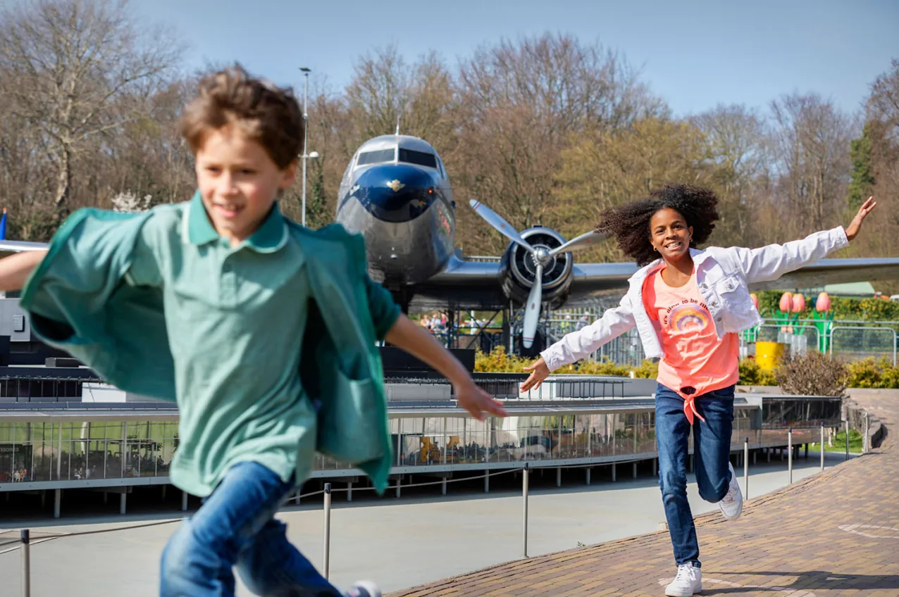 Children playing in front of the Flying Dutchman aircraft at Madurodam.