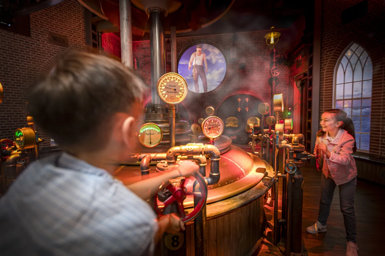 Children operating the interactive controls inside the Waterwolf attraction.